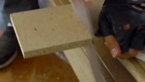 Cropped image of the hands of a skilled craftsman cutting a wooden plank with a Stockbeeldmateriaal 78171712