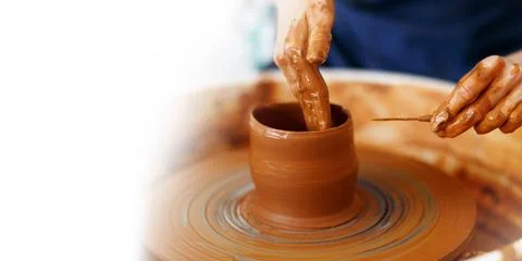 Cropped Image of hands working with Pottery Wheel, close up of shaping clay.. Stock Photos