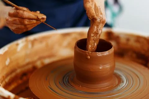 Cropped Image of hands working with Pottery Wheel, close up of shaping clay.. Foto stock