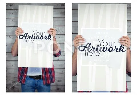 Cropped image of man holding a blank placard in front of his face against wooden PSD Template
