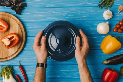 Cropped image man putting pan Stock Photos