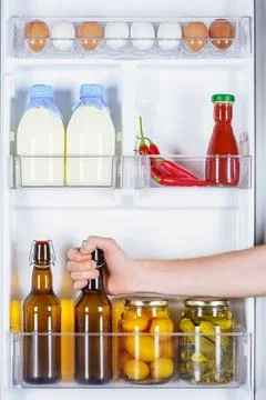 Cropped image man taking bottle Stock Photos