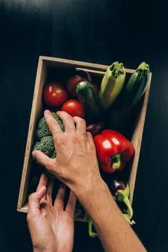 Cropped image man taking broccoli Stock Photos