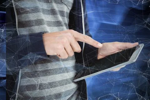 Cropped image of man using tablet against black background with shiny hexagon Stockfoto's