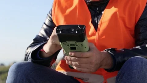 Cropped image of man working with geodetic equipment Stock Footage 75708310