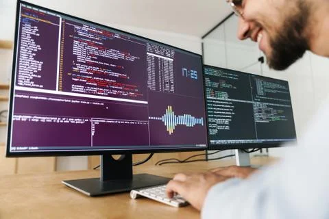 Cropped image of pleased programmer man working with computers Stock Photos