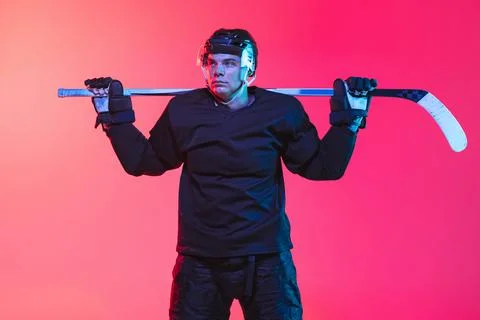 Cropped image of professional hockey playing in uniform with stick isolated over Stock Photos