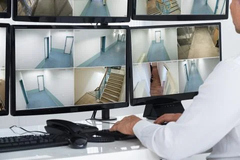 Cropped image of security system operator looking at CCTV footage Foto stock