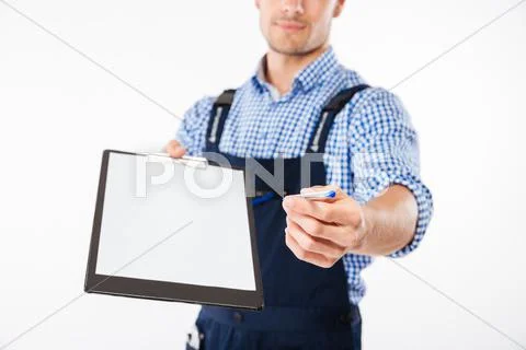 Cropped image of smiling builder giving blank sheet on clipboard Stock Photos