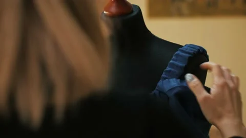 Cropped image of tailor putting pin into dress on mannequin Video stock 153814680