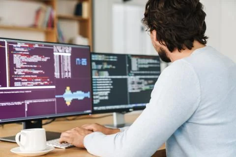 Cropped image of unshaven programmer man working with computers Stock Photos