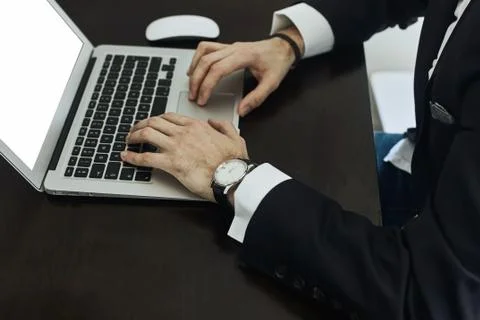 Cropped image of a young man working on his laptop rear view of business man Stock Photos