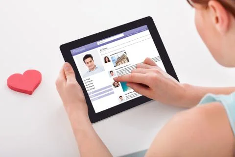 Cropped image of young woman chatting on social networking sites using digita Stock Photos