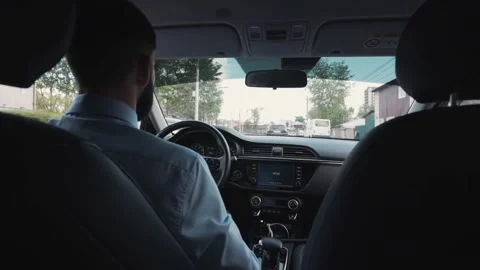 Cropped of man driving car, over shoulder shot. hands on steering wheel inside Video stock 336265524