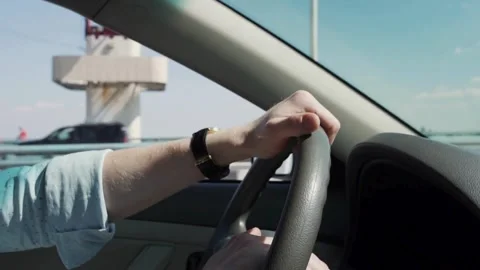 Cropped of man driving car. Unrecognizable driver holding hands on steering Stock-Footage 336265614