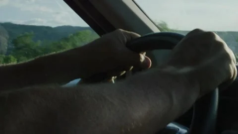 Cropped of man driving car. Unrecognizable driver holding hands on steering Stock-Footage 336265757