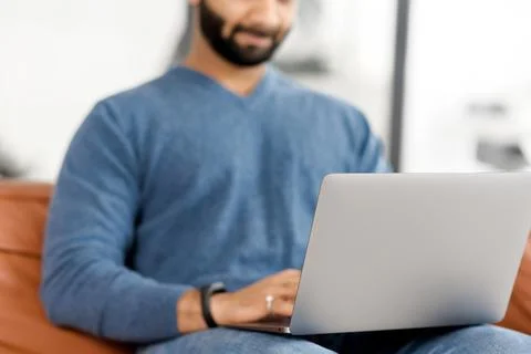 Cropped picture of Indian man using laptop, Hispanic guy is typing on the Stock Photos