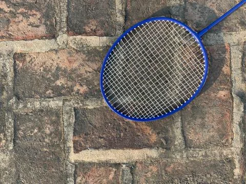 Cropped Racket for playing badminton on a rough background. Stock Photos