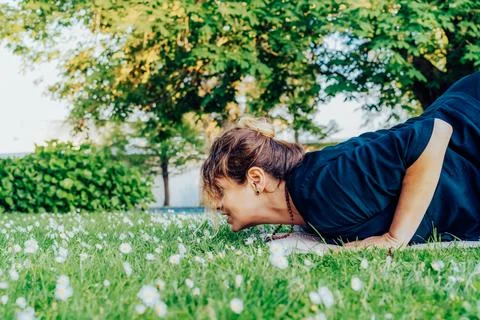 Cropped Relaxed middle aged plus size Caucasian woman enjoying practicing Stock Photos