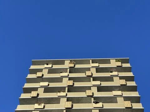 Cropped shot of abstract pattern of a modern architecture building on a sunny Stock Photos