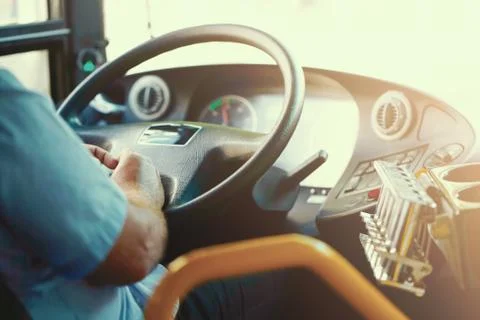 Cropped shot of bus driver holding steering whee Stock Photos
