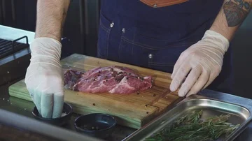 Cropped shot of a chef adding salt on pork meat before cooking steak Stock Footage 86159002