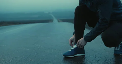 Cropped shot close up of unrecognizable man in sportswear tying up laces on Stock Footage 148330018