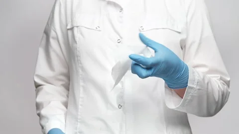 Cropped shot of a doctor pulling out from  pack tissue or wet wipe, showing i Stock Footage 238611938