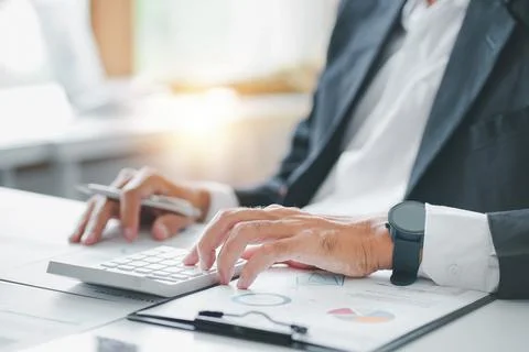 Cropped shot of estate agent using calculator calculate for contract to buy or Stock Photos