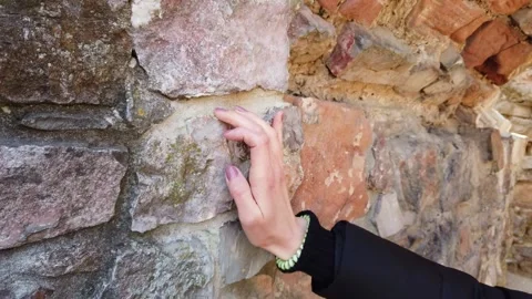Cropped shot of human hand touching stone wall. Stock Footage 133791794