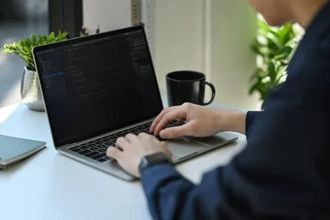 Cropped shot of IT developer typing on laptop with programming code on computer 스톡 사진
