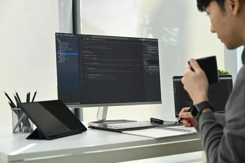 Cropped shot of male software developers working with coded data on computer Stock Photos
