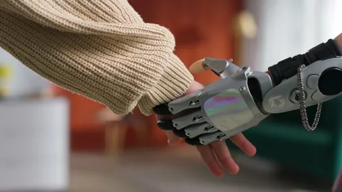 Cropped shot of man with bionic arm and young woman holding hands Stock Footage 243640705