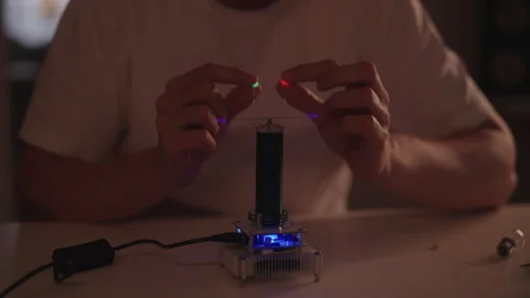 Cropped shot of man demonstrating wireless energy transfer with tesla coil Stock Footage 324865956