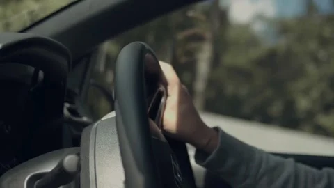 Cropped shot of man with his hands on steering wheel, driving his car. Stock-Footage 336268457