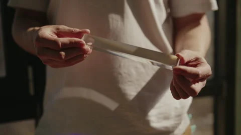 Cropped shot of man holding triangular glass prism, refracting sunlight and Stock Footage 311569509