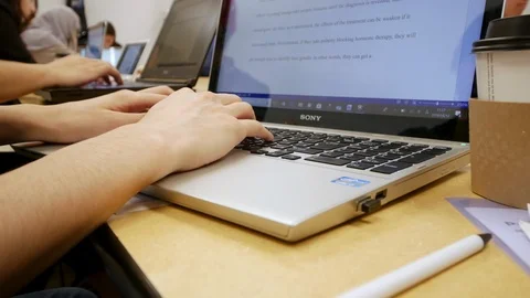 Cropped shot of a man’s hands typing on a laptop with a mug of coffee Stock Footage 88562641
