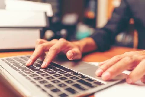 Cropped shot of a man's hands using a laptop at home, rear view of business m Foto stock