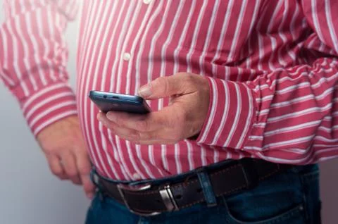 Cropped shot of senior man checking his smartphone Stock Photos