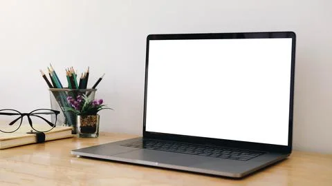 Cropped shot of simple workspace with blank screen laptop, stationery and copy Stock Photos