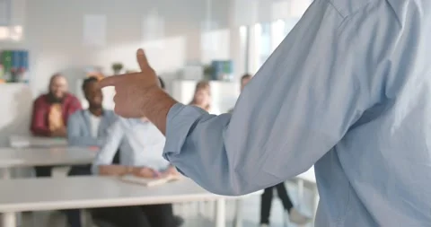 Cropped shot of teacher gesturing hands while giving lecture to students in Stock Footage 154142619