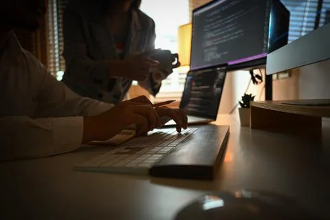 Cropped shot team of software developer working together on a new project in Stockfoto's