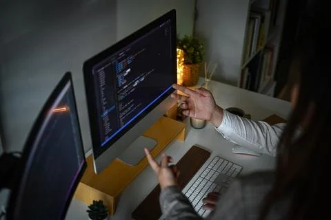 Cropped shot team of software developer programming code on computer screen Stockfoto's