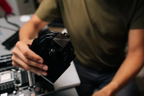 Cropped shot of unrecognizable computer technician installing CPU cooler onto Stock Photos