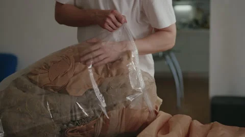 Cropped shot of unrecognizable man putting curtains away in large vacuum storage Stock Footage 312331136