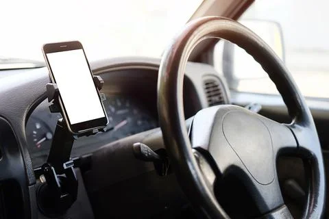 Cropped shot view The driver uses the phone while driving. Modern smart phone Stock Photos