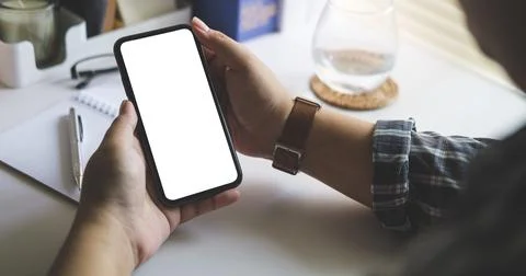 Cropped shot view of man using smart phone at office desk. Blank  screen fo.. Stock Photos