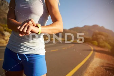 Cropped shot of woman checking her sports watch Stock Photos