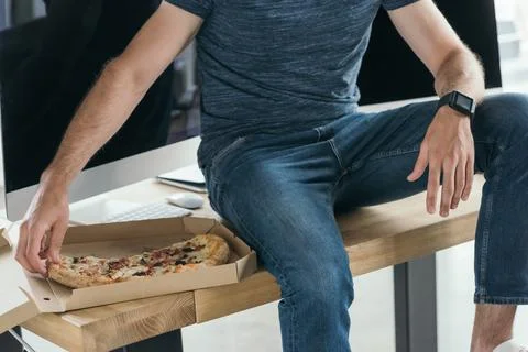 Cropped shot young programmer eating Stock-Fotos