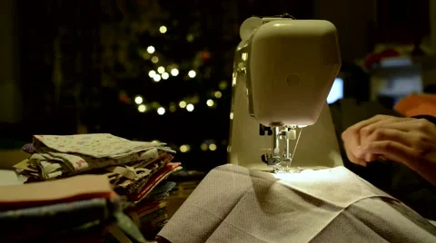 Cropped side view of hands stitching piece of fabric on automatic sewing machine Video stock 46054684